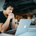 man in front of laptop with earphonese on