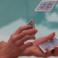 close up of hands holding cards