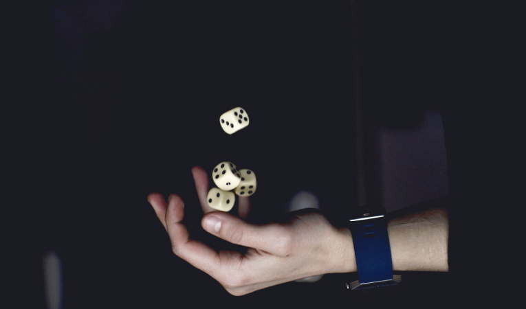 dice falling into a hand